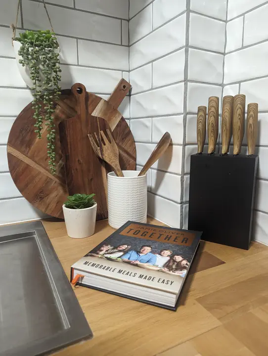 Chopping boards, knives and a cookbook ready to go