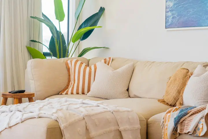 A deep, comfortable sofa piled with cushions